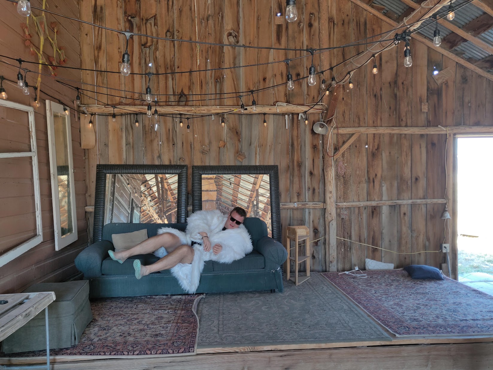 Interior of Black Karma Camp barn with string lights